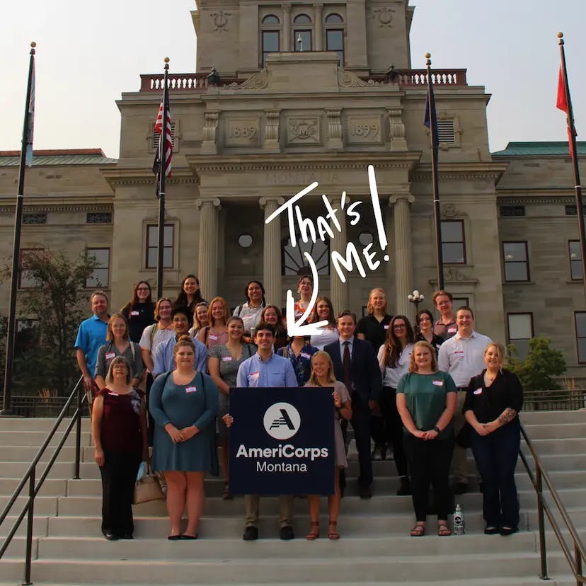 A photograph of me and others in from of the Montana state capital for the AmeriCorps. The image is annotated with an arrow pointing ot me.